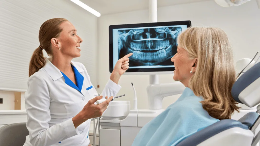 Dentist showing a dental X-ray to a UK patient during a safe dental consultation in Turkey