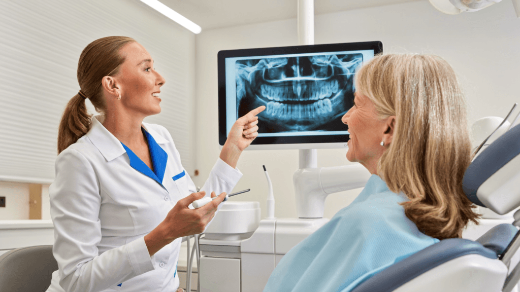 Dentist showing a dental X-ray to a UK patient during a safe dental consultation in Turkey